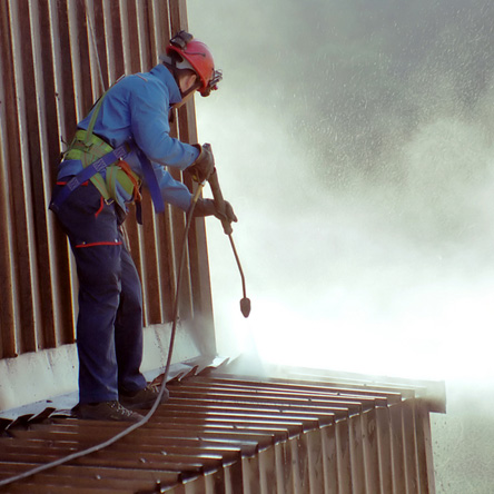 Worker,In,Cherry-picker,Washing,A,Wall